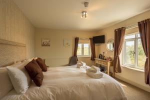 a bedroom with a bed with towels on it at The Sail Loft in Southwold