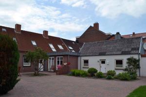 a group of houses with a brick driveway at Ferienhaus-Am-Strand-Haus-2 in Eckernförde