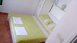a small bed in a small room with two towels at Apartments Ivica Mateljak in Brist