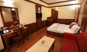 Postel nebo postele na pokoji v ubytování Hotel Vishnu Palace