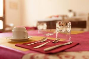 a table with a red napkin with a fork and knife at Joy Living in Sandra