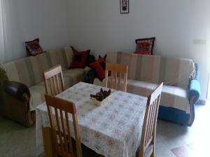 a living room with a table and a couch at House Nada in Donji Babin Potok +22 photos