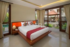 a bedroom with a bed with a bow on it at Pondok Massas Ubud in Ubud +50 photos