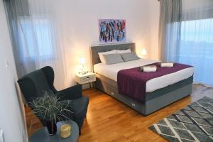 a small bedroom with a bed and a chair at Apartmani Valis in Matulji +46 photos