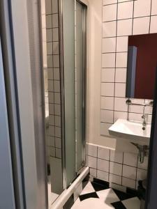 a bathroom with a sink and a toilet and a mirror at Hotelové Pokoje Kolčavka in Prague