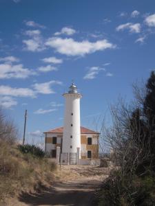 a lighthouse on the side of a dirt road at Hotel Garni Losanna in Bibione