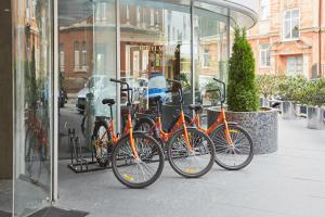 four bikes parked in front of a store window at Hotel Marton Palace in Kaliningrad