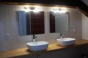 a bathroom with two sinks and two mirrors at La grange de Bastard in Saint-Gor +21 photos