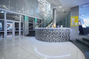 a lobby with a staircase in a building at Hotel Marton Palace in Kaliningrad