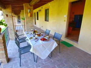 a table with a white table cloth on a patio at Luxurious Farmhouse in Montalcino with Pool in Montalcino