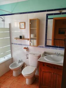 a bathroom with a toilet and a sink and a tub at Chipionabeachhouse in Chipiona