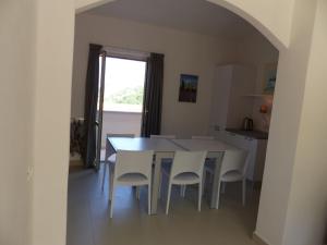 a kitchen and dining room with a table and chairs at Chic Apartment in Parghelia Italy in Parghelia