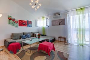 a living room with a couch and a table at The Look in Mali Lošinj
