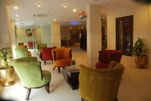 
a living room filled with lots of furniture at Hotel Classic Diplomat in New Delhi
