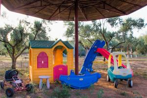 a group of childrens play equipment sitting under an umbrella at Ktima Anastasia Green Stay Nafplio in Nafplio +57 photos