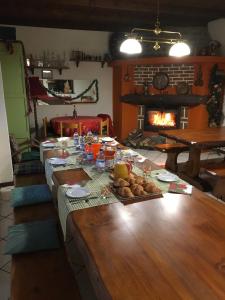 a long table with food on it with a fireplace at Boscotenso in Premosello Chiovenda