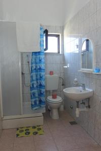a bathroom with a toilet and a sink at Apartmani Vesna Supetar in Supetar