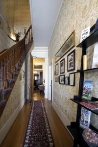 a hallway with stairs and a rug on the floor at Inn at the Agora in Lewiston