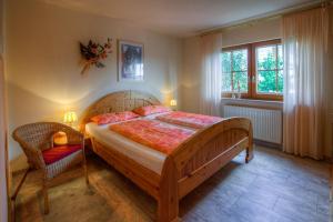 a bedroom with a large wooden bed and a chair at KaLü Apartments in Braunlage