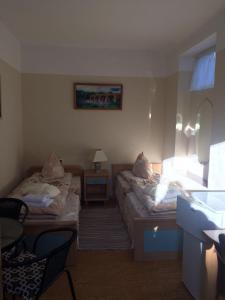 a hotel room with two beds and a window at Viesu Nams Mežu 13 in Ventspils
