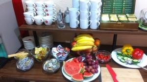 a table topped with plates of fruits and vegetables at Sportpenzion Pohoda in Pilsen