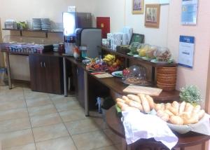 a kitchen with a counter with lots of food at Sportpenzion Pohoda in Pilsen