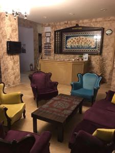 a living room with several chairs and a table at Hbs Hotel in Kuşadası