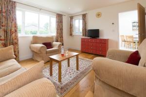 a living room with two couches and a coffee table at 2 Suffolk Cottage, Knodishall in Aldringham