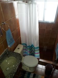 a bathroom with a toilet and a sink and a shower at Secret Recreio in Rio de Janeiro +26 photos