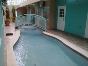 a pool of water with a bridge in a building at Ella's Park View Townhouse Crown Point in Crown Point