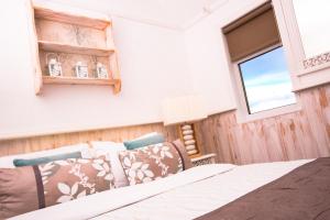 a bedroom with a bed and a window at Haylie Hotel in Largs +2 photos