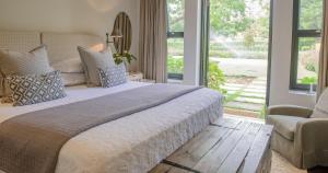 a bedroom with a large bed and a couch at Torburnlea Homestead Luxury Accommodation in Nelspruit