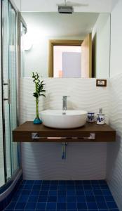a bathroom with a sink and a mirror at Terrazza Marconi in Salerno