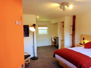 a bedroom with a bed and a desk and a lamp at Heliotrope Hotel in Bellingham