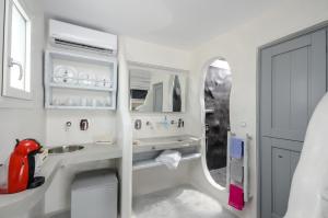 a white bathroom with a sink and a mirror at Naxian Althea in Agia Anna Naxos +53 photos