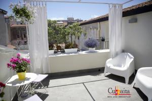 a balcony with a view of a garden at B&B Cubbaita in Palermo