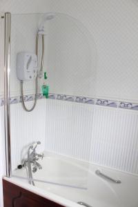 a bathroom with a shower and a bath tub at Garden View Self Catering Lough Rynn in Mohill