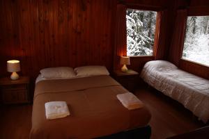Una cama o camas en una habitación de Hosteria Las Cartas