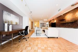 an office with a brick wall and desks and chairs at Chelsea Pines Inn in New York