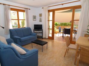 a living room with two blue couches and a table at Apartment Son Durí Seawiews 15 in Sa Ràpita