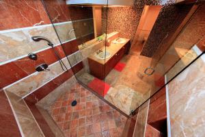 a bathroom with a shower with a sink and a toilet at Chelsea Pines Inn in New York