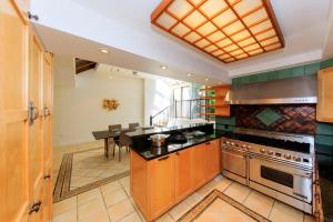 a kitchen with a stove and a table in it at Chelsea Pines Inn in New York
