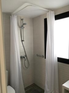 a shower with a white shower curtain in a bathroom at Vivienda Vacacional Casa Federico in Corralejo +54 photos
