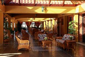 a patio with chairs and tables and chairs at Hotel Los Parrales in Tarija