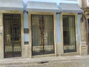 a building with a large window and a dog on it's hind legs at Belomont52 Guest House in Porto