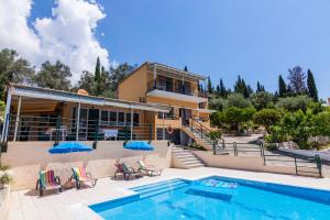 a villa with a swimming pool and a house at Ipsos Pool Apartments, Elena & Maria by Konnect in Ýpsos