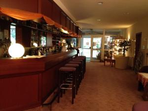 a bar with a row of stools in a restaurant at Landhotel Trampe in Trampe