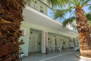 a view of the front porch of a house with a palm tree at Summer Dream in Vlachata