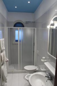 a bathroom with a shower and a toilet and a sink at Aparthotel Villa Marinù in Ischia