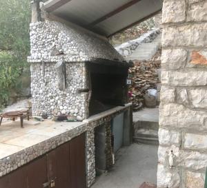 an outdoor pizza oven in a stone wall at Apartment Ljilja in Blato